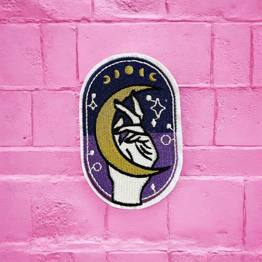 Purple and blue hand holding moon embroidery patch